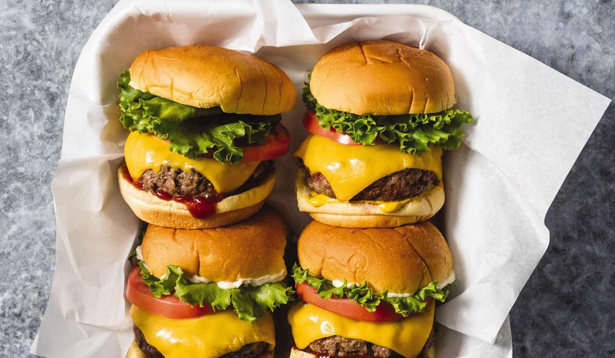 This undated photo provided by America's Test Kitchen in May 2019 shows Classic Beef Burgers in Brookline, Mass. This recipe appears in the cookbook "The Ultimate Burger." (Daniel J. van Ackere/America's Test Kitchen via AP) ** FILE **
