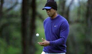 Tiger Woods flips his ball as he walks along the ninth green during a practice round for the PGA Championship golf tournament, Monday, May 13, 2019, in Farmingdale, N.Y. (AP Photo/Julie Jacobson) ** FILE **