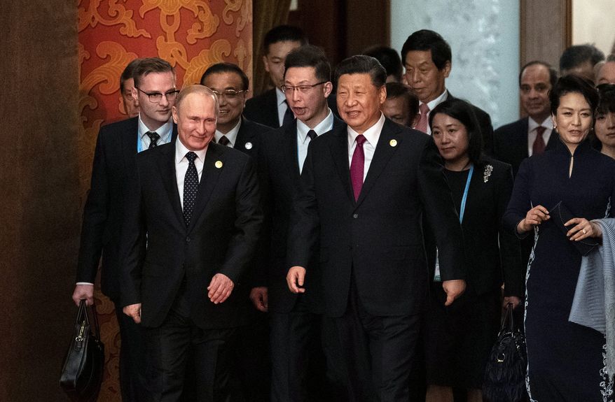 In a think tank report, a senior fellow referred to the relationship between Russia and China as an "emerging China-Russia Axis." (Associated Press)
