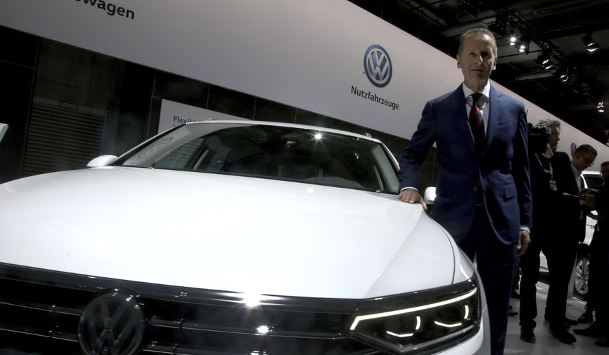 Herbert Diess, CEO of the Volkswagen stock company, poses next to a Volkswagen car prior to the company&#x27;s annual general meeting in Berlin, Germany, Tuesday, May 14, 2019. (AP Photo/Michael Sohn)