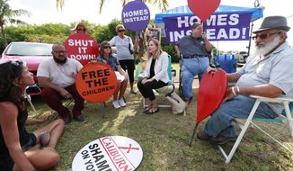 Representative Debbie Mucarsel-Powell, center, D-Fla., talks with demonstrators before attempting to enter the Homestead Temporary Shelter for Unaccompanied Children, Monday, May 6, 2019, in Homestead, Fla. Mucarsel-Powell was denied access to the shelter. (AP Photo/Wilfredo Lee)