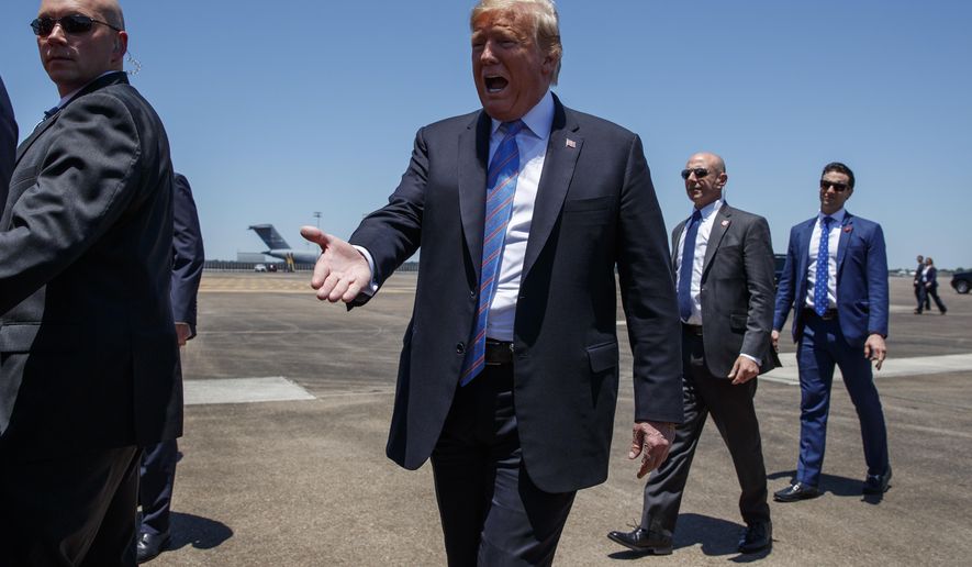 President Donald Trump reaches out to greet supporters after arriving at Chennault International Airport, Tuesday, May 14, 2019, in Lake Charles, La. (AP Photo/Evan Vucci)