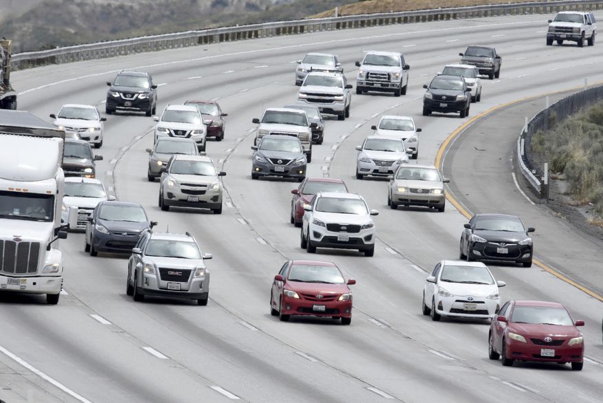 Traffic is seen on the Interstate 15 in the Cajon Pass, on Wednesday, May 15, 2019, near Hesperia, Calif. The Auto Club is reporting the the upcoming Memorial Day weekend may break another record for southern California travelers on the Interstates. (James Quigg/The Daily Press via AP)