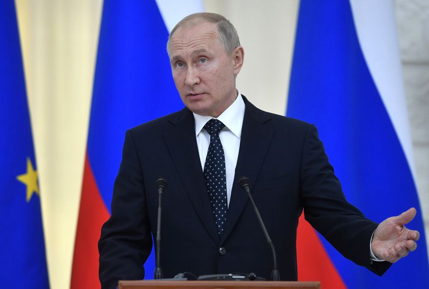 Russian President Vladimir Putin gestures during his and Austrian President Alexander Van der Bellen's joint news conference in Moscow, Wednesday, May 15, 2019. (Alexander Nemenov/Pool Photo via AP)