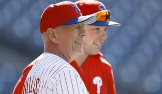 Actor Bruce Willis talks with Philadelphia Phillies&#39; Rhys Hoskins during batting practice before a baseball game against the Milwaukee Brewers, Wednesday, May 15, 2019, in Philadelphia. (AP Photo/Matt Slocum)