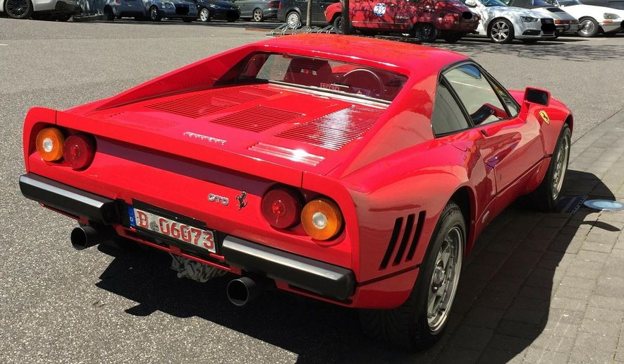 The Monday, May 13, 2019 photo provided by the police in Duesseldorf shows the Ferrari 288 GTO. German police have recovered a valuable 1980s Ferrari stolen during a test drive and are now searching for the man who is believed to have sped off with the car while posing as a would-be buyer. The red Ferrari 288 GTO, first registered in 1985, is believed to be worth more than 2 million euros ($2.2 million). (Police Duesseldorf via AP)