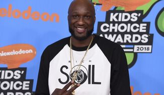 FILE - In this March 24, 2018 file photo, Lamar Odom arrives at the Kids&#39; Choice Awards at The Forum in Inglewood, Calif. Odom regrets cheating on ex Khloé Kardashian and lying to her about his addiction to cocaine during their four-year marriage. The 39-year-old tells People magazine he wishes he “could have been more of a man” and it still bothers him three years after they divorced.  (Photo by Jordan Strauss/Invision/AP, File)