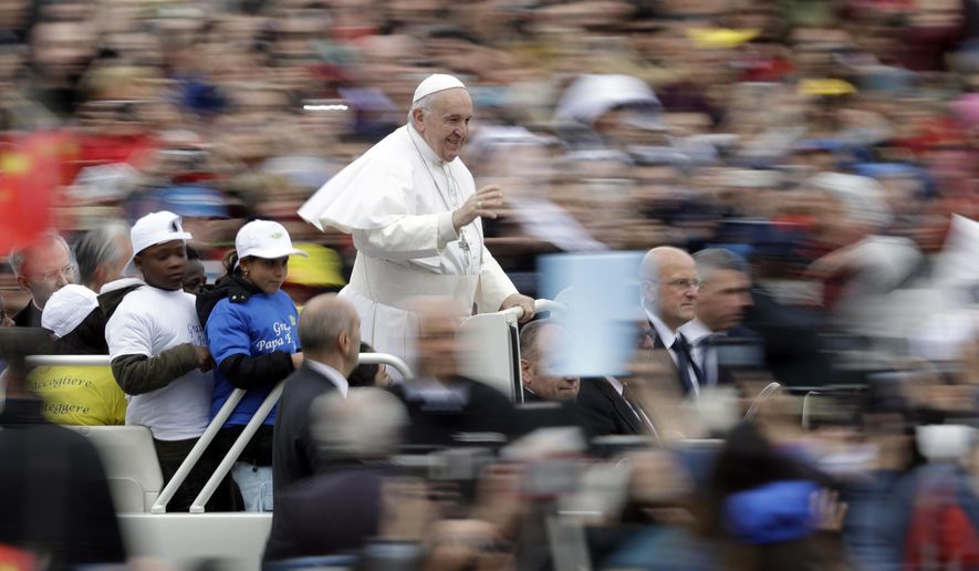 Pope Francis rides with a group of children on his popemobile at the start of his weekly general audience in St. Peter's Square, at the Vatican, Wednesday May 15, 2019. (AP Photo/Andrew Medichini)