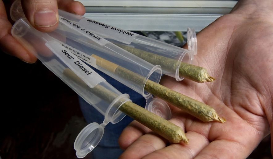 In this Oct.13, 2016, file photo, pre-rolled marijuana cigarettes are displayed at a medical marijuana dispensary near Laytonville, Calif. (AP Photo/Rich Pedroncelli, File)