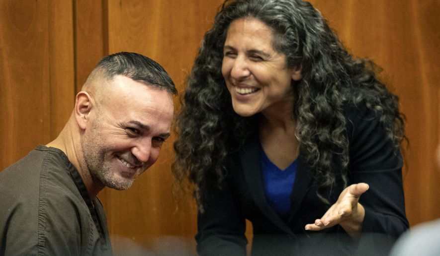 In this Wednesday, May 15, 2019 photo, Lionel Rubalcava talks with Northern California Innocence Project lead attorney Paige Kaneb before his attempted murder conviction was dismissed by a judge in San Jose, Calif. Rubalcava, a Northern California man wrongfully convicted in a 2002 drive-by shooting that left a man paralyzed, was exonerated and freed after 17 years in prison. (Karl Mondon/San Jose Mercury News via AP)