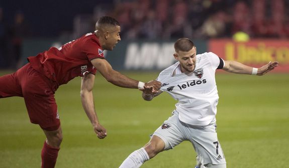 Toronto FC defender Justin Morrow (2) pulls down D.C. United forward Paul Arriola (7) during the second half of an MLS soccer game, Wednesday, May 15, 2019 in Toronto. (Nathan Denette/The Canadian Press via AP) ** FILE **