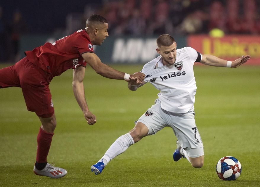 Toronto FC defender Justin Morrow (2) pulls down D.C. United forward Paul Arriola (7) during the second half of an MLS soccer game, Wednesday, May 15, 2019 in Toronto. (Nathan Denette/The Canadian Press via AP) ** FILE **