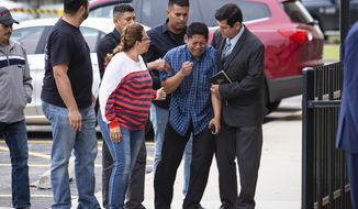 Arnulfo Ochoa, the father of Marlen Ochoa-Lopez, is surrounded by family members and supporters, as he walks into the Cook County medical examiner&#x27;s office to identify his daughter&#x27;s body, Thursday, May 16, 2019 in Chicago. (Ashlee Rezin/Chicago Sun-Times via AP)