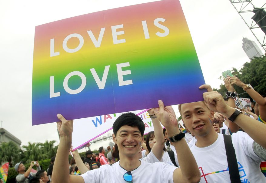 FILE - In this Saturday, Oct. 31, 2015, file photo, revelers participate in a gay pride parade in Taipei, Taiwan. Taiwanese legislators are scheduled to decide Friday on legalizing same-sex marriage, marking a potential first in Asia. (AP Photo/Chiang Ying-ying, File)