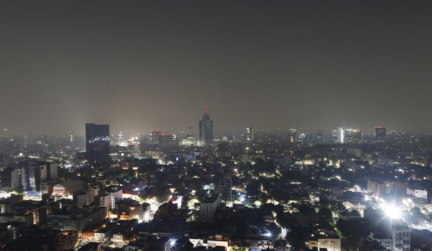 Smoke and pollution hangs over in Mexico City, early Thursday, May 16, 2019. Mexico City officials cancelled classes for millions of students for a second straight day as smoke from brush fires continued to choke the city. (AP Photo/Marco Ugarte)