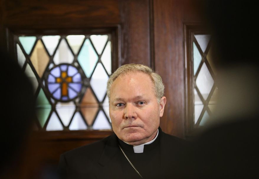 Dallas Bishop Edward J. Burns speaks to members of the media following a police raid on several Diocese of Dallas offices, Wednesday, May 15, 2019, at Holy Trinity Catholic Church in Dallas. A police commander says a search at the Catholic Diocese of Dallas began when an investigation into child sexual abuse allegations against a former priest uncovered claims against others. (Ryan Michalesko/The Dallas Morning News via AP)