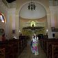In this May 11, 2019 photo, a tourist walks through a Spanish-style church at the Hermitage of Monserrate, in Matanzas, Cuba. In total, Cuba drew 4.7 million tourists in 2018, a 1.3% rise over the previous year that puts its latest goal of 5 million within reach. (AP Photo/Ismael Francisco)