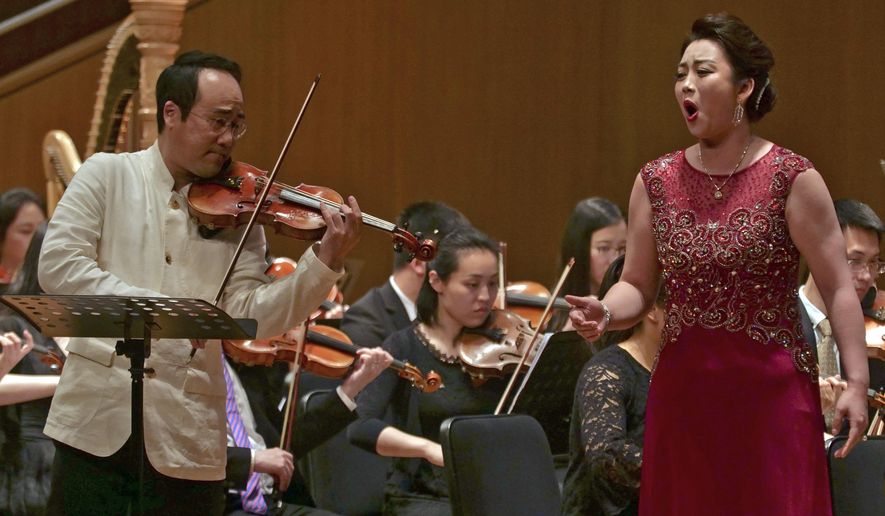 In this Sunday, May 12, 2019, file photo, South Korean violinist Won Hyung Joon and his North Korean soprano partner Kim Song Mi perform at the Shanghai Oriental Arts Center in Shanghai. Won, a South Korean, performed together with Kim, a North Korean, in a rare joint performance they hope would help bring the divided Koreas closer together via music. Their performance comes three days after North Korea fired two suspected short-range missiles in the second such weapons test in five days. (AP Photo/Dake Kang, File)