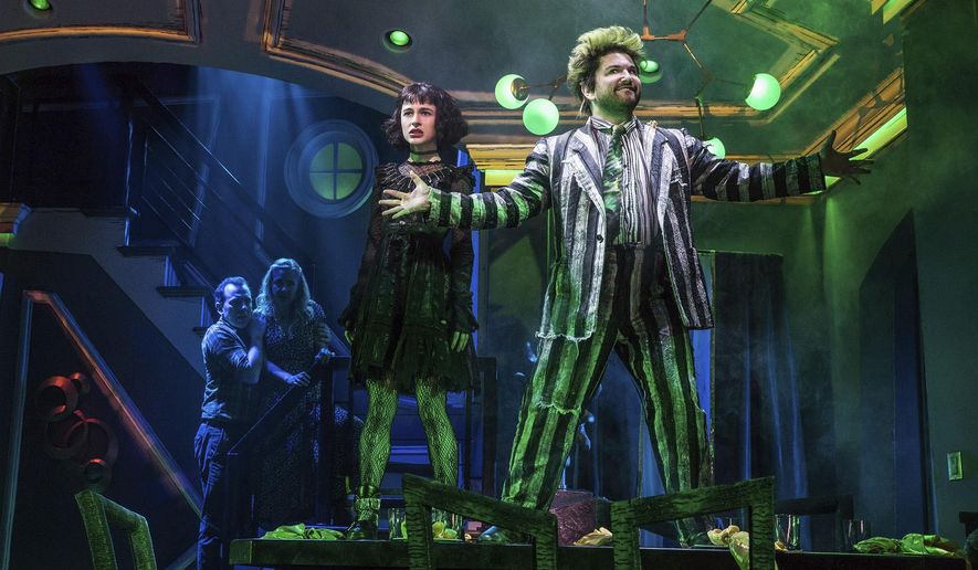This image released by Polk & Co. shows Rob McClure, from left, Kerry Butler, Sophia Anne Caruso and Alex Brightman during a performance of "Beetlejuice," in New York. The Tony-nominated “Beetlejuice” is a stage adaptation of the Tim Burton dark comedy. (Matthew Murphy/Polk & Co. via AP)