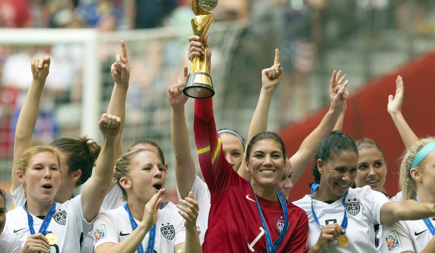 FILE - In this July 5, 2015, file photo, United States goalkeeper Hope Solo hoists the trophy as she and her teammates celebrate defeating Japan to win the FIFA Women&#39;s World Cup soccer championship in Vancouver, British Columbia, Canada. Solo was in goal four years ago in Canada when the United States won soccer’s most prestigious tournament. She has no regrets about her acrimonious breakup with the team, which will seek to defend its title at the Women’s World Cup in France.  (Darryl Dyck/The Canadian Press via AP)