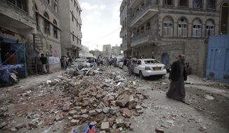 People inspect the site of an airstrike by Saudi-led coalition forces, in Sanaa, Yemen, Thursday, May, 16, 2019. Yemen&#39;s human rights minister says heavy fighting is underway in the country&#39;s south as rebel Houthis push to gain more territory from government forces and their allies. The clashes come as the Saudi-led coalition carried out airstrikes on the capital, Sanaa, earlier on Thursday, targeting the Houthis and killing at least three civilians. (AP Photo/Hani Mohammed)