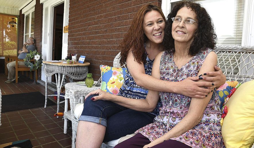 Shannon Barbero, of Beckley, W.Va. hugs her mother Tammy Evans, of Beckley at her moms home on May 6, 2019, one month after she donating half her liver to save her mothers life. (Rick Barbero/The Register-Herald via AP)