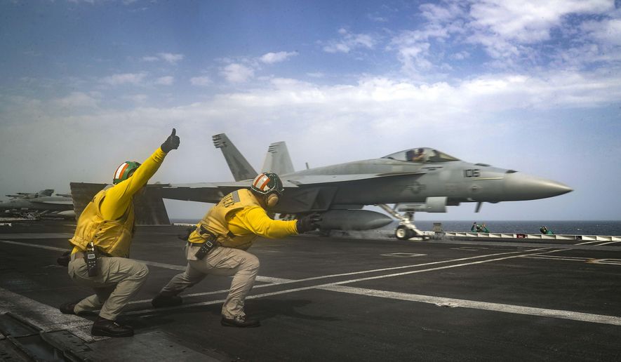 In this Thursday, May 16, 2019 photo released by the U.S. Navy, Lt. Nicholas Miller, from Spring, Texas, and Lt. Sean Ryan, from Gautier, Miss., launch an F-18 Super Hornet from the deck of the USS Abraham Lincoln aircraft carrier in the Arabian Sea. On Saturday, May 18, 2019, U.S. diplomats warned that commercial airliners flying over the wider Persian Gulf faced a risk of being &amp;quot;misidentified&amp;quot; amid heightened tensions between the U.S. and Iran. (Mass Communication Specialist 3rd Class Jeff Sherman, U.S. Navy via AP)