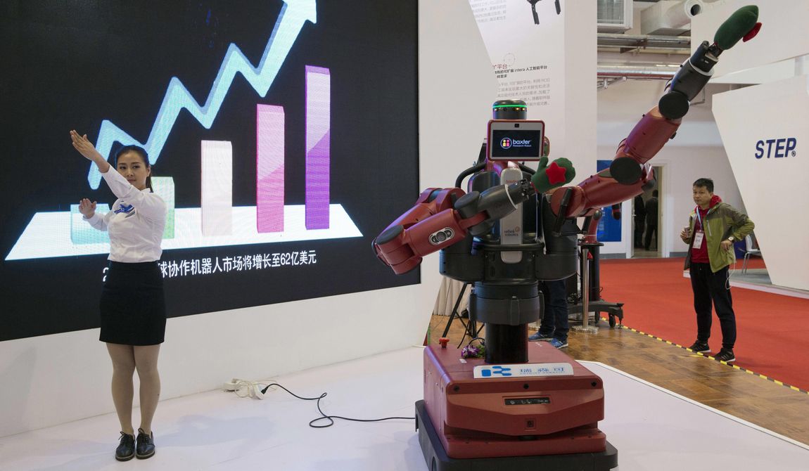 In this Oct. 21, 2016 photo, a Chinese woman demonstrates the ability of Baxter, an industrial robot from U.S. company Rethink Robotics, to follow her hand movements during the World Robot Conference in Beijing. For four decades, Beijing has cajoled or pressured foreign companies to hand over technology. And its trading partners say if that didn&#x27;t work, China stole what it wanted. (AP Photo/Ng Han Guan) **FILE**