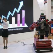 In this Oct. 21, 2016 photo, a Chinese woman demonstrates the ability of Baxter, an industrial robot from U.S. company Rethink Robotics, to follow her hand movements during the World Robot Conference in Beijing. For four decades, Beijing has cajoled or pressured foreign companies to hand over technology. And its trading partners say if that didn&#x27;t work, China stole what it wanted. (AP Photo/Ng Han Guan) **FILE**