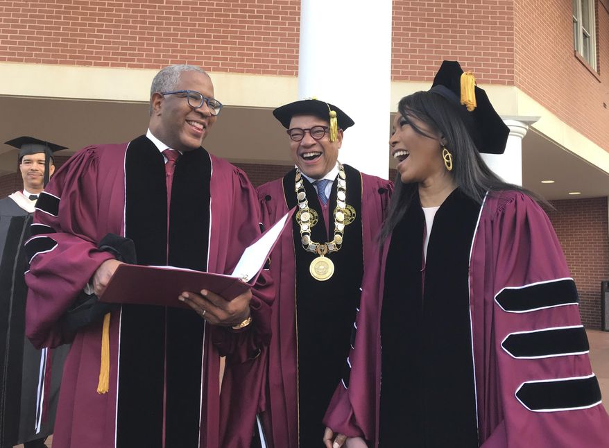 Robert F. Smith, left, laughs with David Thomas, center, and actress Angela Bassett at Morehouse College on Sunday, May 19, 2019, in Atlanta. Smith, a billionaire technology investor and philanthropist, said he will provide grants to wipe out the student debt of the entire graduating class at Morehouse College - an estimated $40 million. Smith, this year&#x27;s commencement speaker, made the announcement Sunday morning while addressing nearly 400 graduating seniors of the all-male historically black college in Atlanta.  (Bo Emerson/Atlanta Journal-Constitution via AP)
