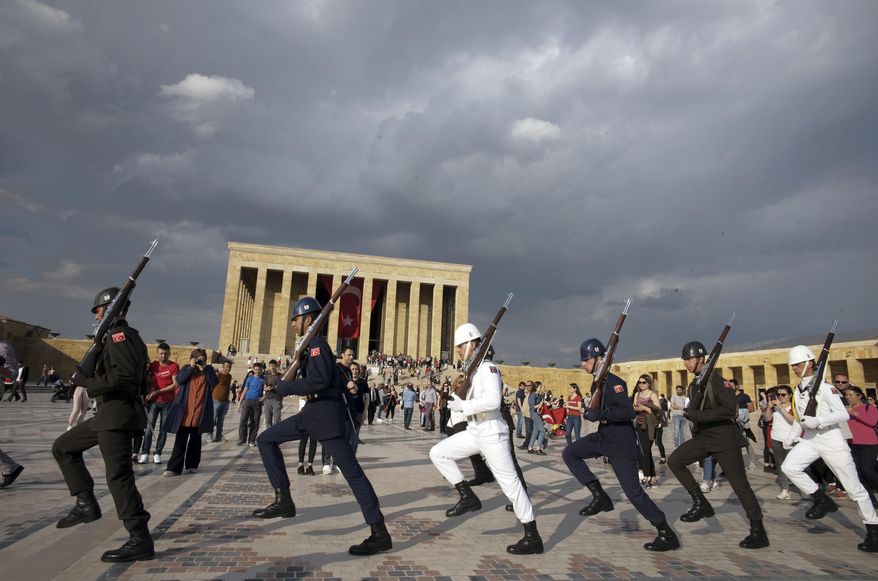 Soldiers march during a changing of guard ceremony as thousands of people visit the mausoleum of Mustafa Kemal Ataturk, the founder of modern Turkey, to pay respect on the day marking the 100th anniversary of the start of Turkey's War of Independence under the leadership of young Ottoman army general, Mustafa Kemal (Ataturk), 38, in Ankara, Turkey, Sunday, May 19, 2019.(AP Photo/Burhan Ozbilici)