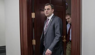 This March 28, 2017, file photo shows Rep. Justin Amash, R-Mich., followed by Rep. Jim Jordan, R-Ohio, leaving a closed-door strategy session on Capitol Hill in Washington. Amash isn’t taking back his call for President Trump’s impeachment. (AP Photo/J. Scott Applewhite, File) ** FILE **