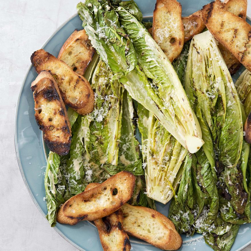 This undated photo provided by America's Test Kitchen in May 2019 shows Grilled Caesar Salad in Brookline, Mass. This recipe appears in the cookbook “Vegetables Illustrated.” (Joe Keller/America's Test Kitchen via AP)