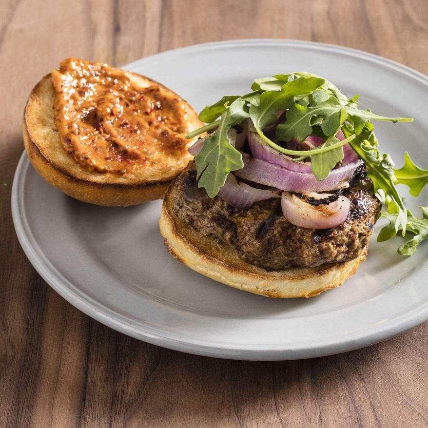 This undated photo provided by America's Test Kitchen in May 2019 shows Grilled Harissa Lamb Burgers in Brookline, Mass. This recipe appears in the cookbook “The Ultimate Burger.” (Daniel J. van Ackere/America's Test Kitchen via AP)