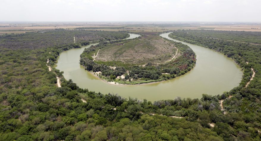 FILE - In this July 24, 2014, file photo, a bend in the Rio Grand is viewed from a Texas Department of Public Safety helicopter on patrol over in Mission, Texas. The U.S. government says a teenage Guatemalan died Monday, May 20, 2019, at a Border Patrol station in South Texas, the fifth death of a migrant child since December. U.S. Customs and Border Protection said in a statement that Border Patrol apprehended the teenager in South Texas' Rio Grande Valley on May 13. The agency says the teenager was found unresponsive Monday morning during a welfare check at the agency's Weslaco, Texas, station. The teenager's cause of death is unknown. (AP Photo/Eric Gay, Pool, File)