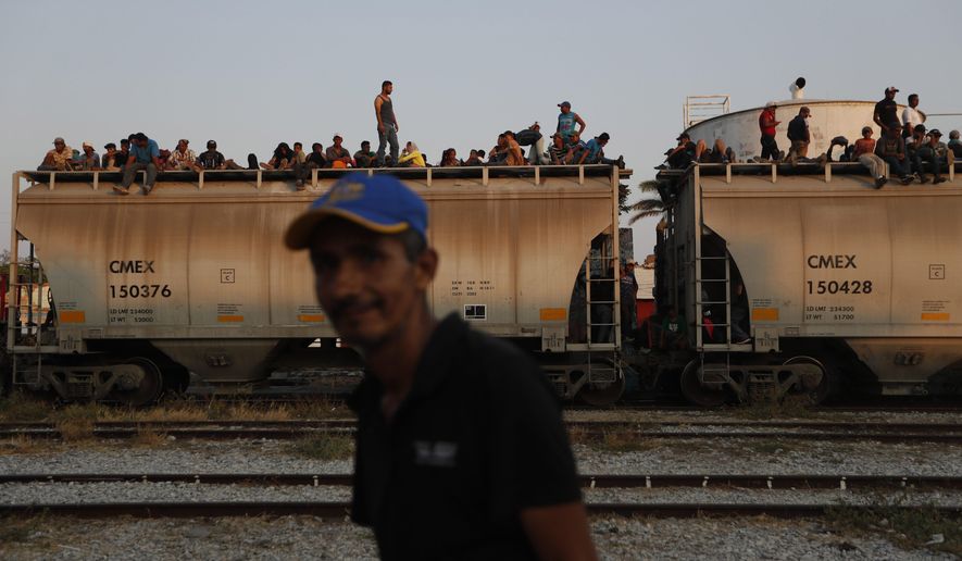 In this April 23, 2019 file photo, Central American migrants ride a freight train on their way to the U.S.-Mexico border, in Ixtepec, Oaxaca state, Mexico. Mexico President Andrés Manuel López Obrador said on Monday, May 20,2019 that U.S. support for economic development in Mexico and Central America is the best option for stemming the flow of immigrants, meanwhile the U.S. and Mexico are discussing an arrangement under which the U.S. government would guarantee some $10 billion in development investments for Mexico and Central America. (AP Photo/Moises Castillo, File)