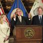 Gov. Tim Walz, center, with Senate Majority Leader Paul Gazelka, right, and House Speaker Melissa Hortman, gestures at a news conference as he was announcing a budget deal in St. Paul, Minn., Sunday, May 19, 2019. Walz and top legislative leaders reached a bipartisan budget deal Sunday in which the governor dropped his proposed gas tax increase but got to keep most of an expiring tax that helps fund health care programs, Republicans got an income tax cut for middle-class Minnesotans and both sides claimed credit for additional spending on education. (Glen Stubbe/Star Tribune via AP)