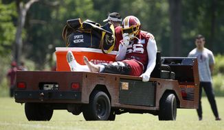 Washington Redskins linebacker Reuben Foster rides a cart off the field after suffering an injury during a practice at the team&#39;s NFL football practice facility, Monday, May 20, 2019, in Ashburn, Va. (AP Photo/Patrick Semansky) ** FILE **