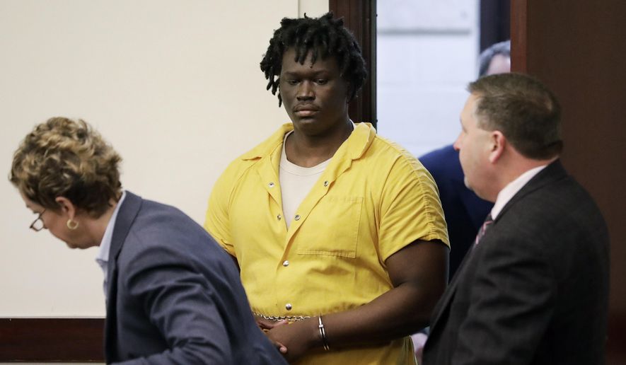 In this Feb. 20, 2019, file photo, Emanuel Kidega Samson, center, enters the courtroom for a hearing in Nashville, Tenn. Prosecutors have said they&#39;re seeking life without parole for 27-year-old Samson, accused of fatally shooting a woman and wounding several people at a Nashville church. His trial is slated to begin Monday, May 20. (AP Photo/Mark Humphrey, File)