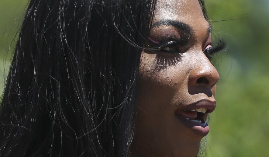 In this Friday, April 20, 2019 photo, Muhlaysia Booker speaks during a rally in Dallas. Booker, a transgender woman seen on a widely circulated video being beaten on April 12 in front of a crowd of people, was found dead Saturday, May 18 in a Dallas shooting. No suspect has been identified. (Ryan Michalesko/The Dallas Morning News via AP)