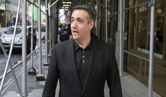 FILE - In this May 4, 2019, file photo, Michael Cohen, President Donald Trump&#39;s former personal attorney, stops to talk to a member of the media in New York. The House intelligence committee has released two transcripts of closed-door interviews with Cohen, along with some exhibits from the testimony. The vote to release the transcript came two weeks after Cohen reported to federal prison for a three-year sentence. (AP Photo/Jonathan Carroll, File)