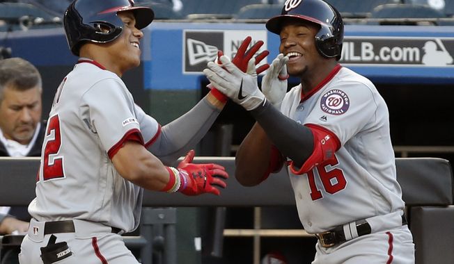 Washington Nationals Juan Soto, left, celebrates with the Nationals&#x27; Victor Robles (16) at the dugout steps after hitting a second-inning, solo home run in a baseball game, Tuesday, May 21, 2019, in New York. (AP Photo/Kathy Willens) ** FILE **