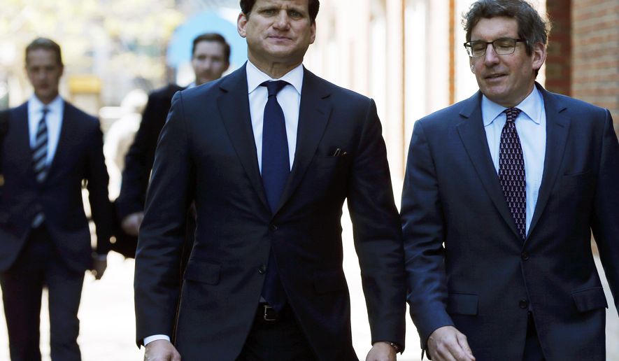 Gordon Caplan, center, arrives at federal court Tuesday, May 21, 2019, in Boston, where he is scheduled to plead guilty to charges in a nationwide college admissions bribery scandal. (AP Photo/Michael Dwyer)