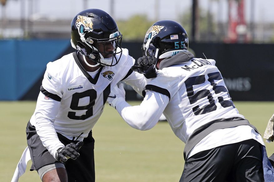 Jacksonville Jaguars defensive end Yannick Ngakoue, left, and defensive end Lerentee McCray (55) perform a drill during the an NFL football practice, Tuesday, May 21, 2019, in Jacksonville, Fla. (AP Photo/John Raoux)