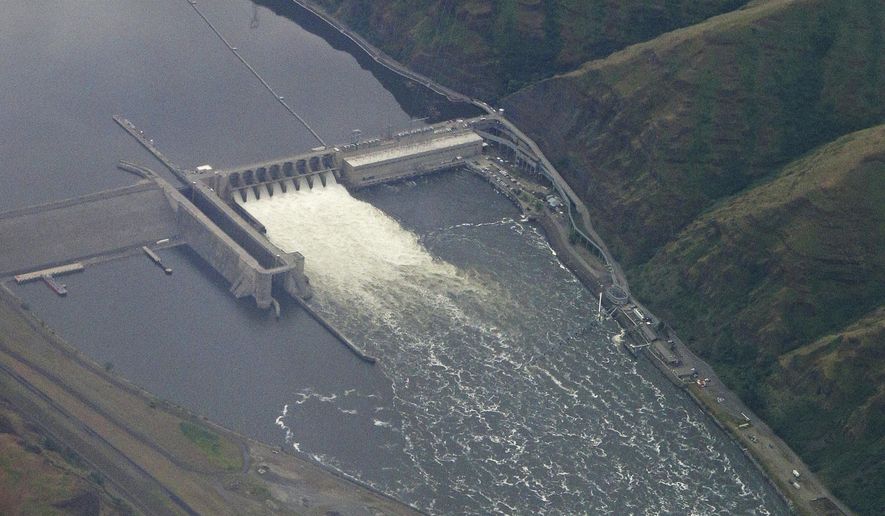 In this May 15, 2019 photo, the Lower Granite Dam on the Snake River is seen from the air near Colfax, Washington Gov. Jay Inslee signed the state's operating budget Tuesday, May 21, 2019 that provides $750,000 to study how to best help impacted communities if the Lower Granite and three other federal dams on the Snake River are breached. The dams are blamed for reducing salmon numbers on the Snake and Columbia river systems. (AP Photo/Ted S. Warren)