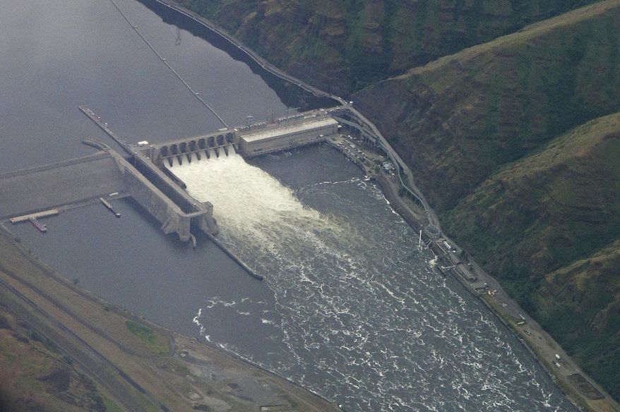 In this May 15, 2019 photo, the Lower Granite Dam on the Snake River is seen from the air near Colfax, Washington Gov. Jay Inslee signed the state's operating budget Tuesday, May 21, 2019 that provides $750,000 to study how to best help impacted communities if the Lower Granite and three other federal dams on the Snake River are breached. The dams are blamed for reducing salmon numbers on the Snake and Columbia river systems. (AP Photo/Ted S. Warren)
