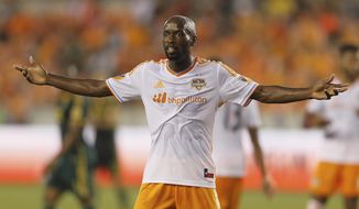 FILE - In this Saturday, May 16, 2015 file photo, Houston Dynamo midfielder DaMarcus Beasley gestures to the linesman for a call in the first half of an MLS soccer game against the Portland Timbers in Houston. DaMarcus Beasley says he will retire at the end of the Houston Dynamo season after 20 years in professional soccer. Beasley, a midfielder and left back, is the only American who has played in four World Cups and the only American to appear in a European Champions League semifinal. He turns 37 on May 24, 2019. (AP Photo/Bob Levey, File)