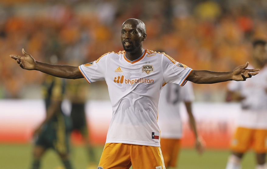 FILE - In this Saturday, May 16, 2015 file photo, Houston Dynamo midfielder DaMarcus Beasley gestures to the linesman for a call in the first half of an MLS soccer game against the Portland Timbers in Houston. DaMarcus Beasley says he will retire at the end of the Houston Dynamo season after 20 years in professional soccer. Beasley, a midfielder and left back, is the only American who has played in four World Cups and the only American to appear in a European Champions League semifinal. He turns 37 on May 24, 2019. (AP Photo/Bob Levey, File)