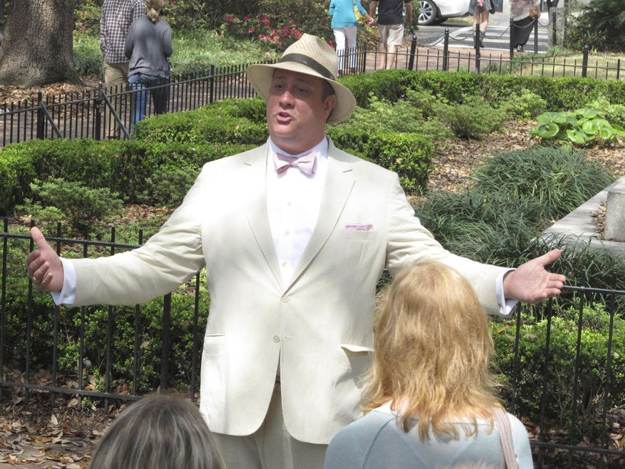 FILE - In this Friday, March 20, 2015 file photo, Dan Leger, who works under the name Savannah Dan, talks with visitors while leading a guided tour of downtown Savannah, Ga. A federal judge says the city of Savannah violated the free-speech rights of tour guides by requiring them to obtain a license under a local law that has since been scrapped. The ruling Monday, May 21, 2019 in U.S. District Court is largely a symbolic victory for Savannah tour guides who sued City Hall more than four years ago over the 1978 licensing ordinance. (AP Photo/Russ Bynum, File)