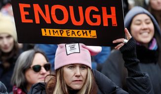 A woman holds a sign expressing her opinion about impeaching President Donald Trump at a rally organized by Women&#39;s March NYC at Foley Square in Lower Manhattan, Saturday, Jan. 19, 2019, in New York. (AP Photo/Kathy Willens) ** FILE **